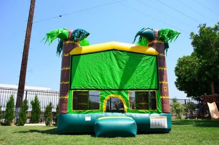 Green bounce house rental inflatable setup for outdoor party event
